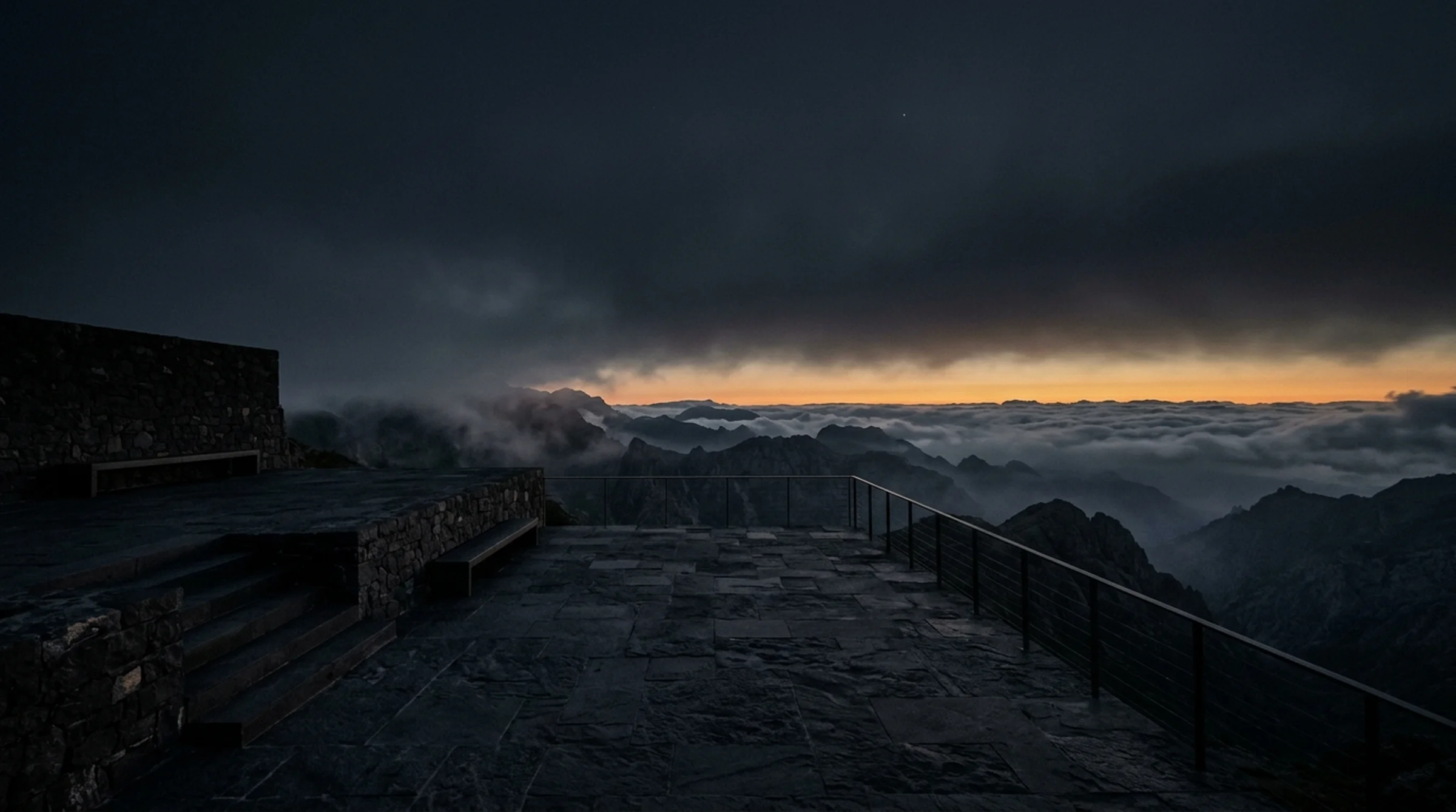 Atmospheric architectural stone terrace overlooking mountain clouds and twilight horizon